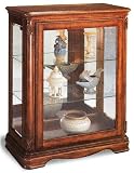 Light cherry finish wood curio cabinet with glass shelves and mirrored back