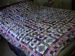 Scrappy 4 patch diamond bed quilt
