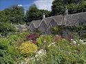 Jigsaw of Traditional Cotswold stone cottages with colourful flower gardens from Robert Harding
