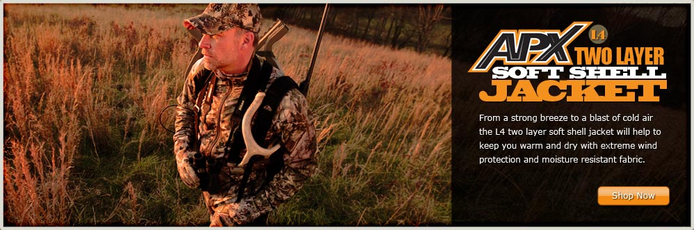 Hunter Walking Through a Field Wearing the Russell Outdoors APXG2 L4 Two Layer Soft Shell Jacket
