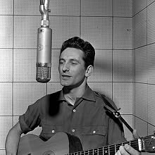 Lonnie Donegan - England. 1956. Singer and musician Lonnie Donegan is pictured at the microphone in a recording studio.