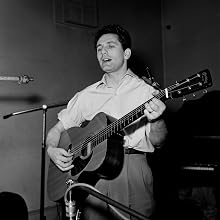 Lonnie Donegan - 1957 Pop and skiffle singer Lonnie Donegan at the microphone in a recording studio.