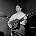 Lonnie Donegan - 1957 Pop and skiffle singer Lonnie Donegan at the microphone in a recording studio.