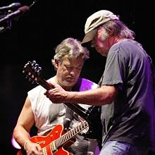 Crazy Horse - Canadian rocker Neil Young (R) jams with
