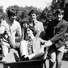 The Kinks - Music Personlaities. pic: 12th August 1964. Left-right, Ray Davies, Peter Quaife, Mick Amory of "The Kinks" pop group giving a ride in a wheelbarrow to fellow band member Dave Davies.