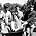 The Kinks - Music Personlaities. pic: 12th August 1964. Left-right, Ray Davies, Peter Quaife, Mick Amory of "The Kinks" pop group giving a ride in a wheelbarrow to fellow band member Dave Davies.